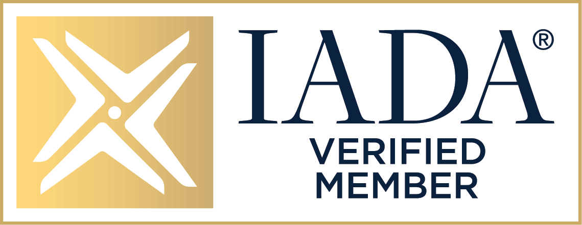 Gold and white logo with an abstract design on the left and the text IADA VERIFIED MEMBER in black capital letters on the right.
